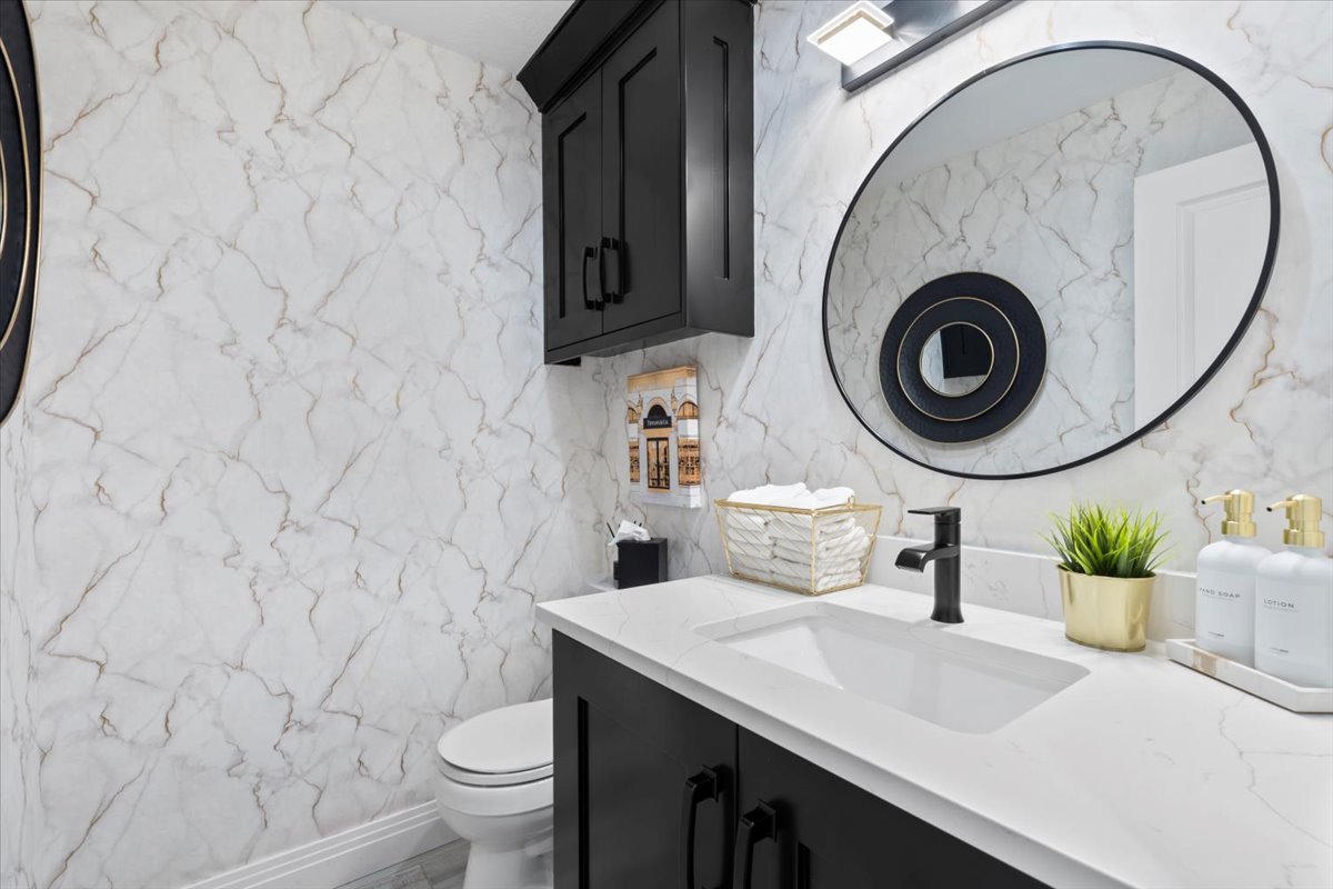 Bathroom featuring vanity and stone wall