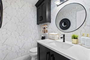 Bathroom featuring vanity and stone wall