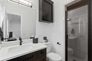 Full bath with vanity, a shower stall, and connected bathroom