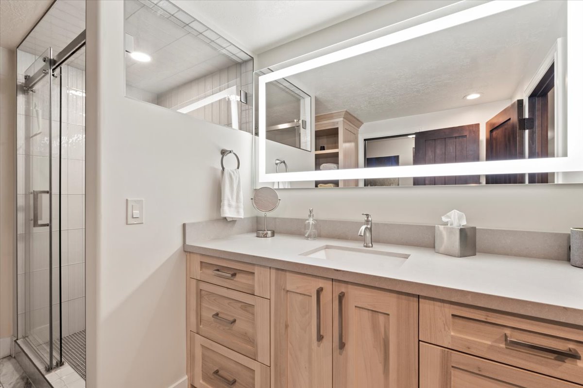 Bathroom featuring vanity, a stall shower, and recessed lighting