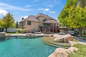 Back of property featuring a patio, a chimney, stucco siding, a pergola, and a gate