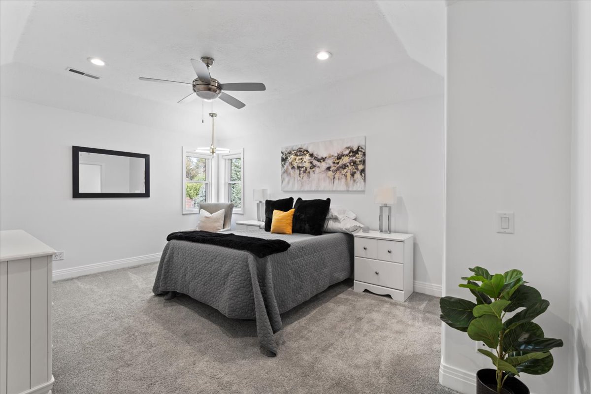 Bedroom featuring light colored carpet, recessed lighting, and a ceiling fan