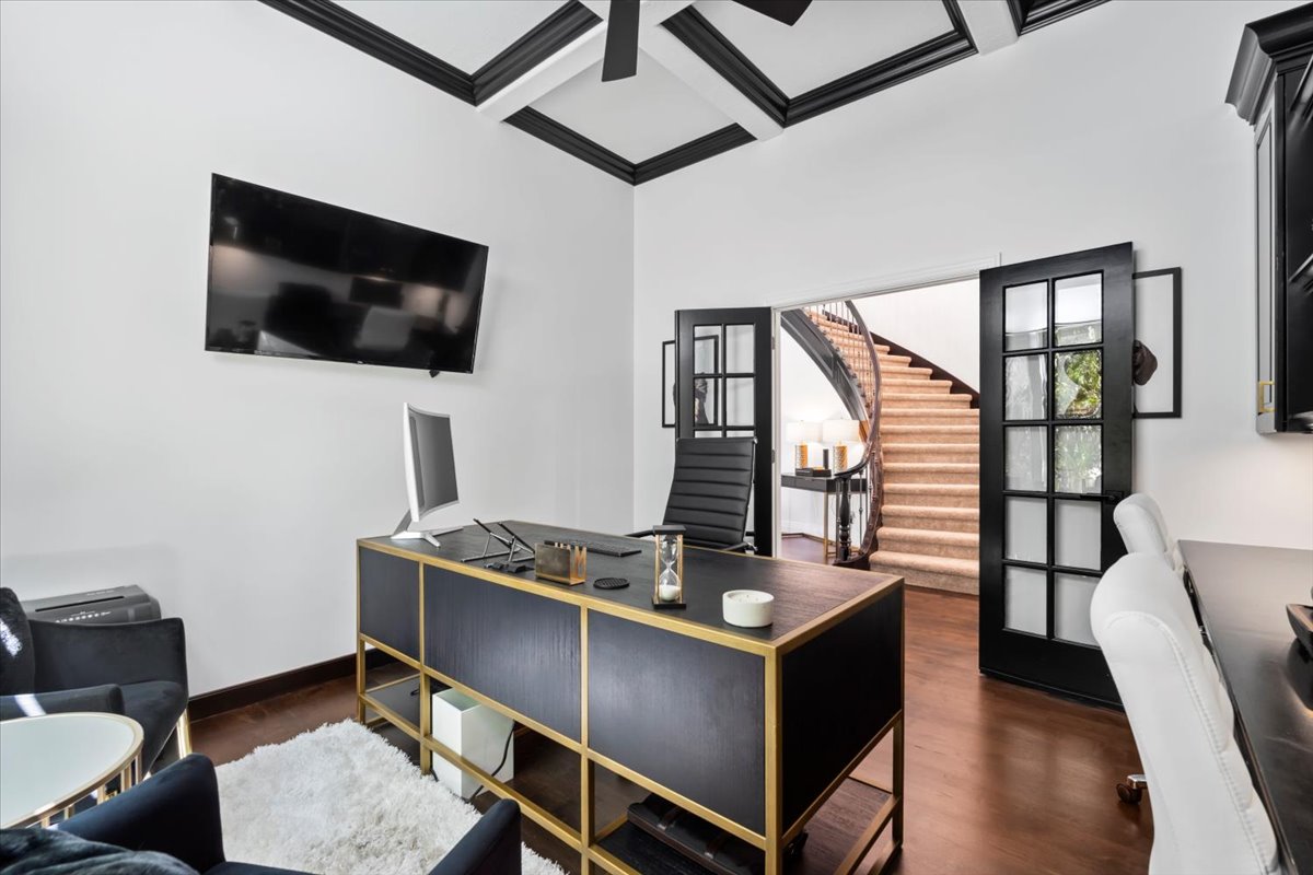 Office featuring coffered ceiling and dark wood finished floors