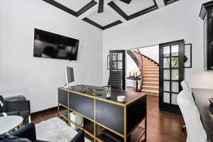Office featuring coffered ceiling and dark wood finished floors