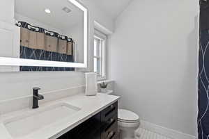 Full bathroom featuring vanity, a shower with shower curtain, and light tile patterned flooring