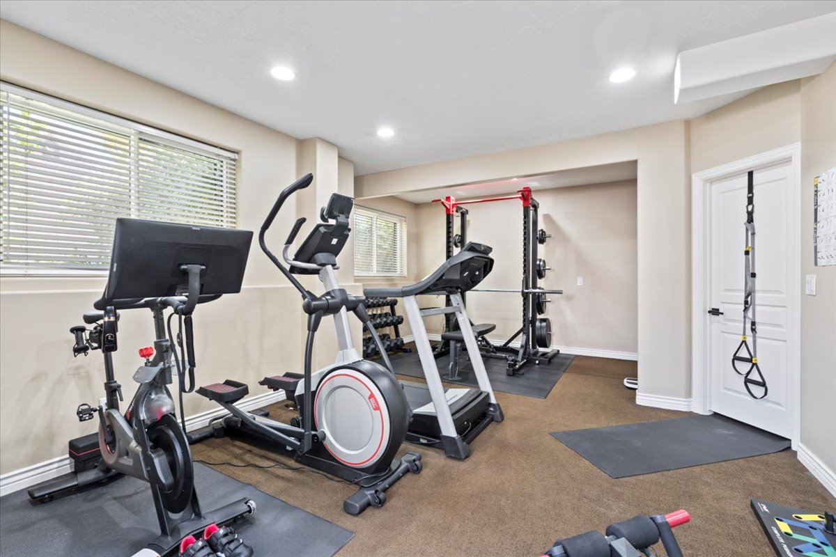 Exercise area with recessed lighting and baseboards