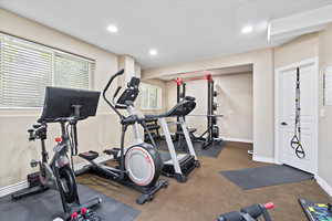 Exercise area with recessed lighting and baseboards
