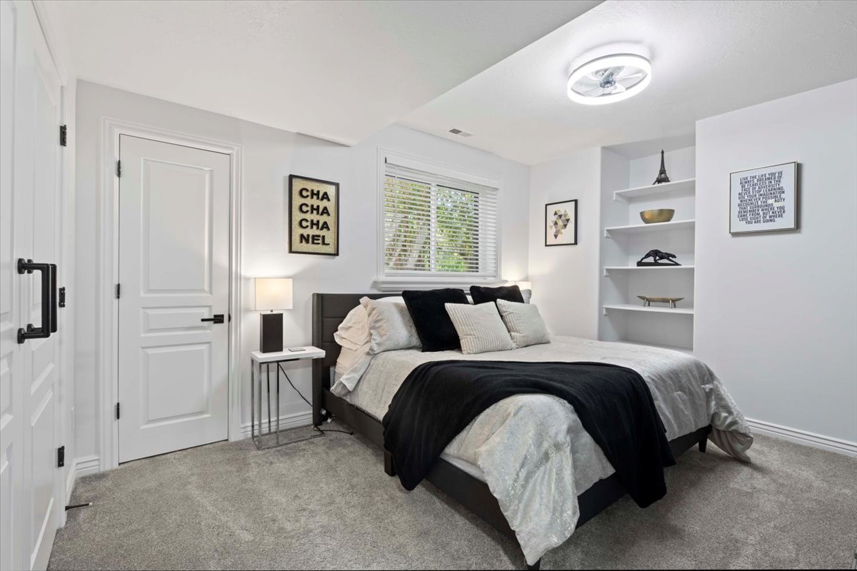 Bedroom with baseboards and light carpet