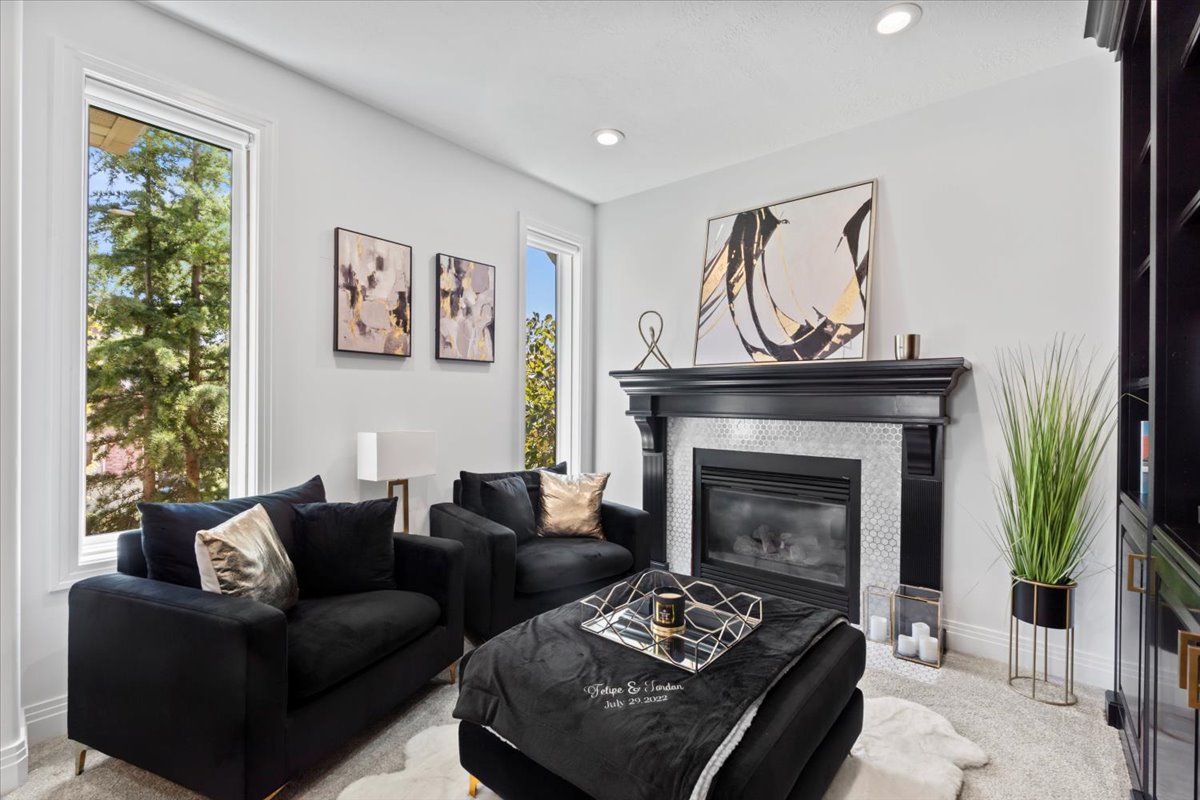 Living room with carpet floors, a fireplace, and recessed lighting