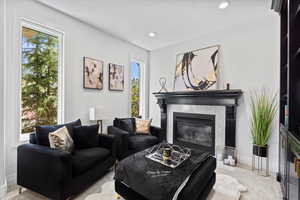 Living room with carpet floors, a fireplace, and recessed lighting