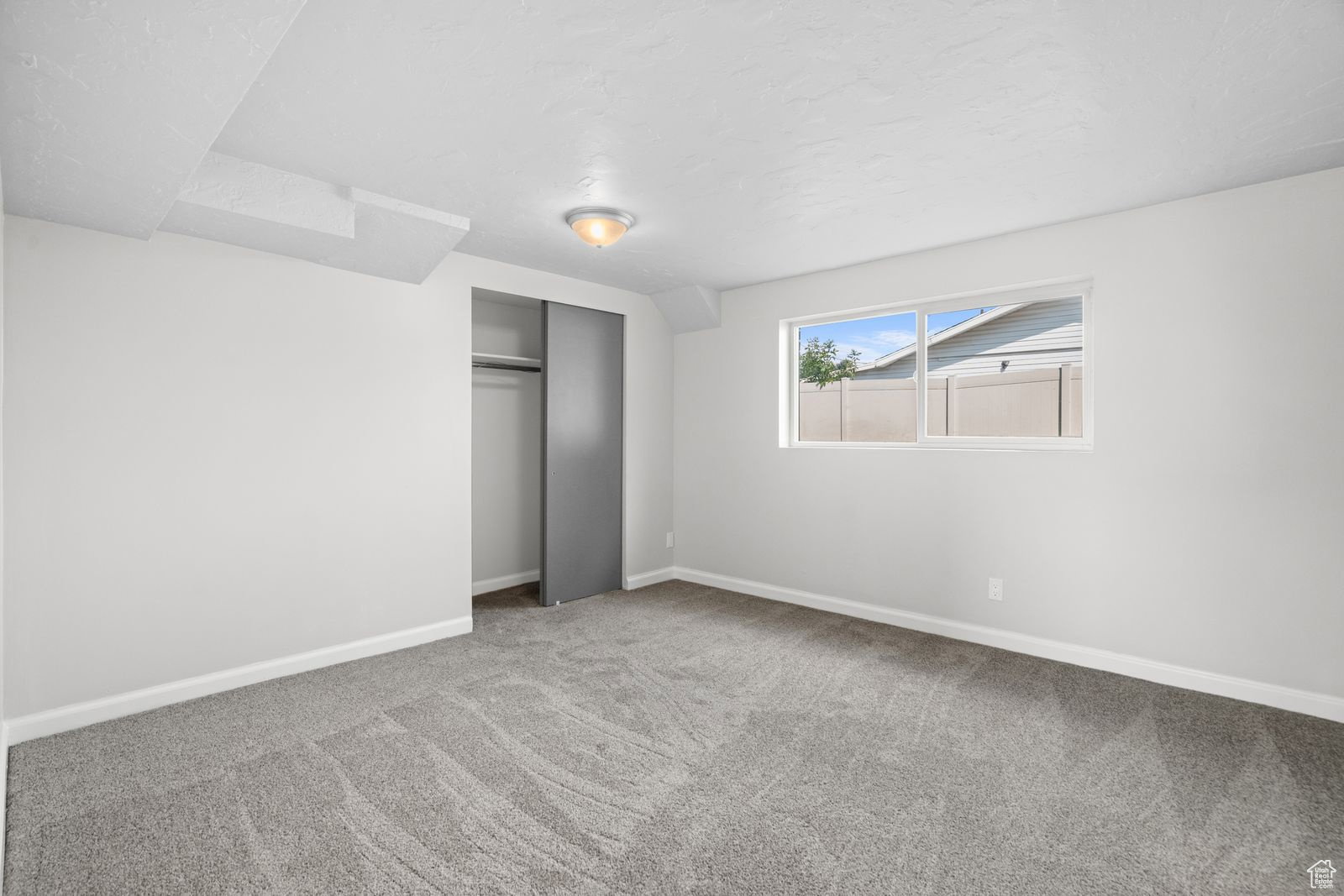 Unfurnished bedroom with a closet and carpet flooring