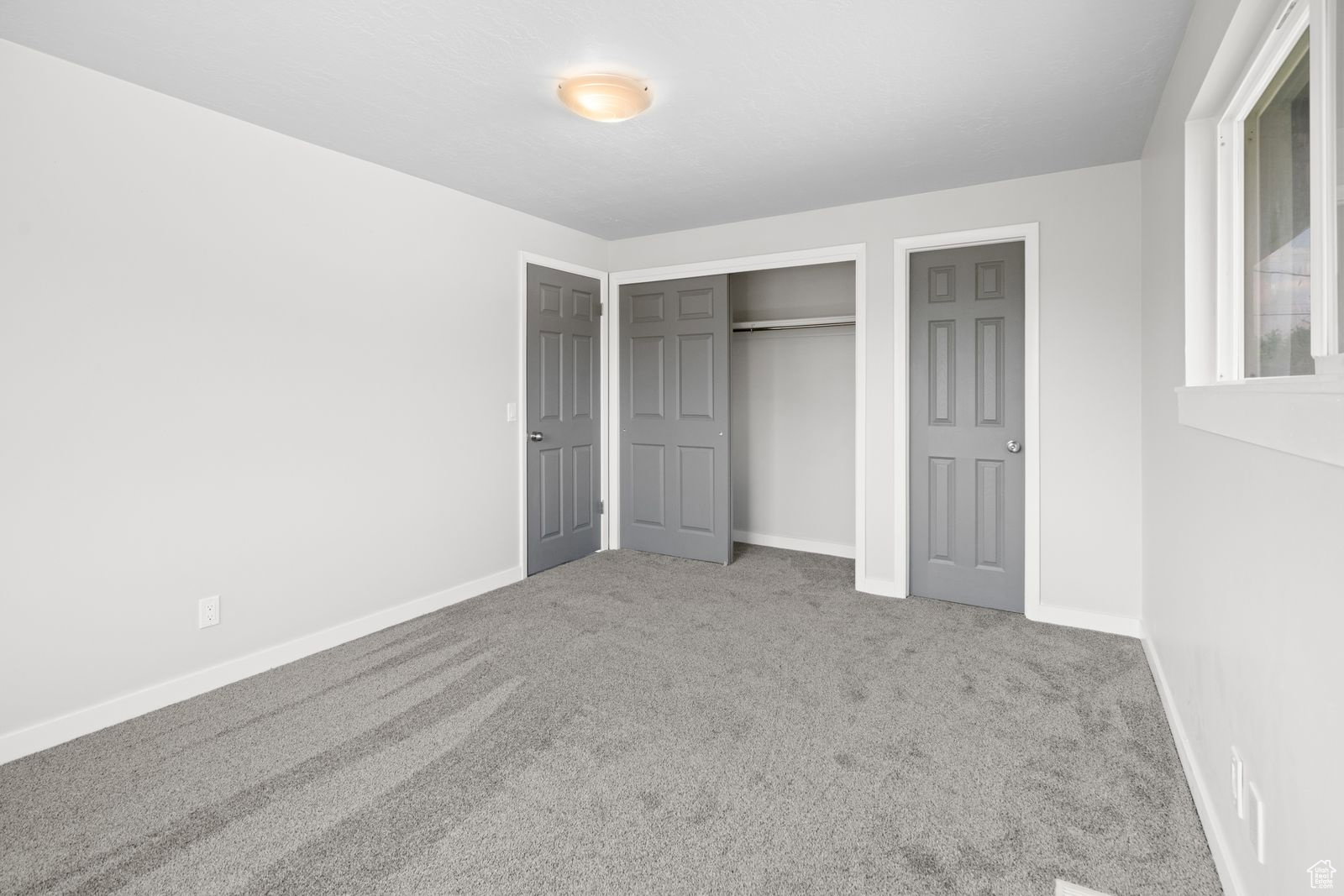 Unfurnished bedroom featuring carpet and a closet