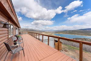 Deck featuring a water and mountain view