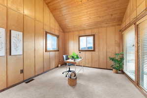 Unfurnished office with light carpet and a vaulted wood ceiling