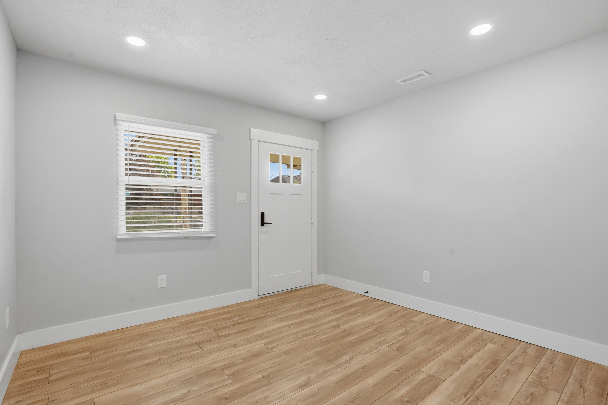Unit #40 Foyer with light wood-style flooring and recessed lighting