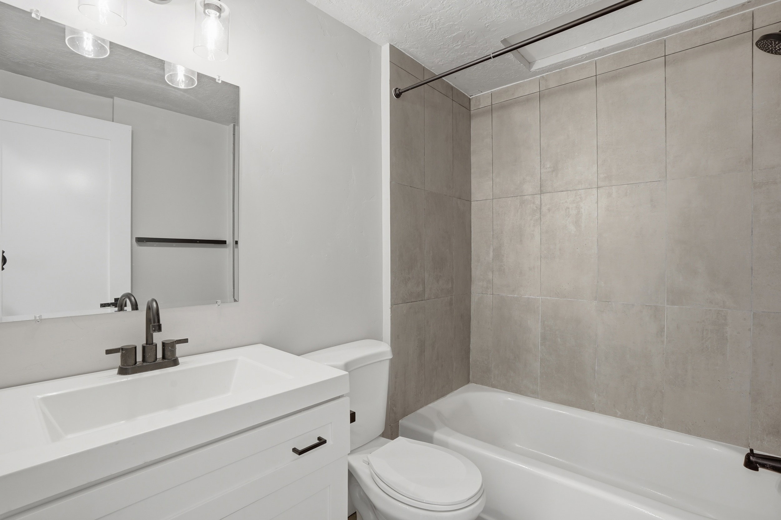 Unit #40 Bathroom with vanity, a textured ceiling, and bathing tub / shower combination