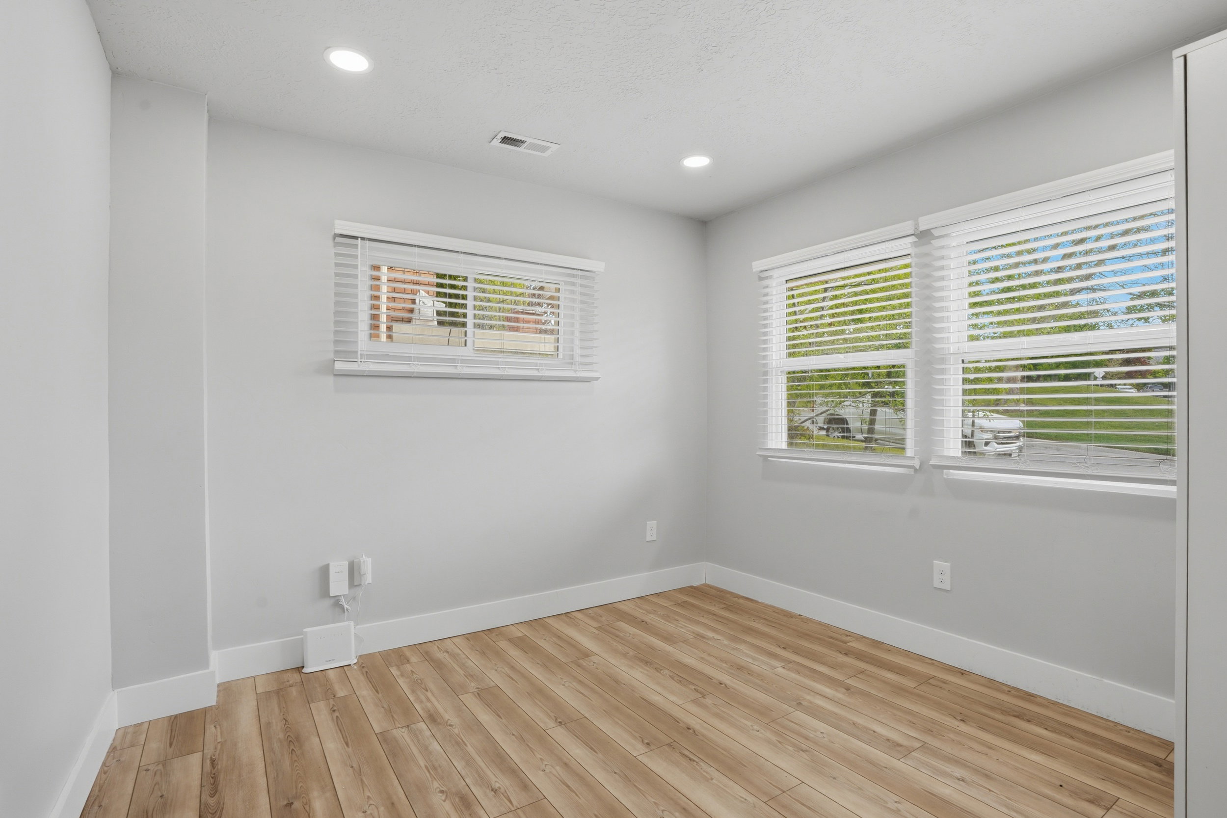 Unit #40 Empty room featuring light wood finished floors and recessed lighting