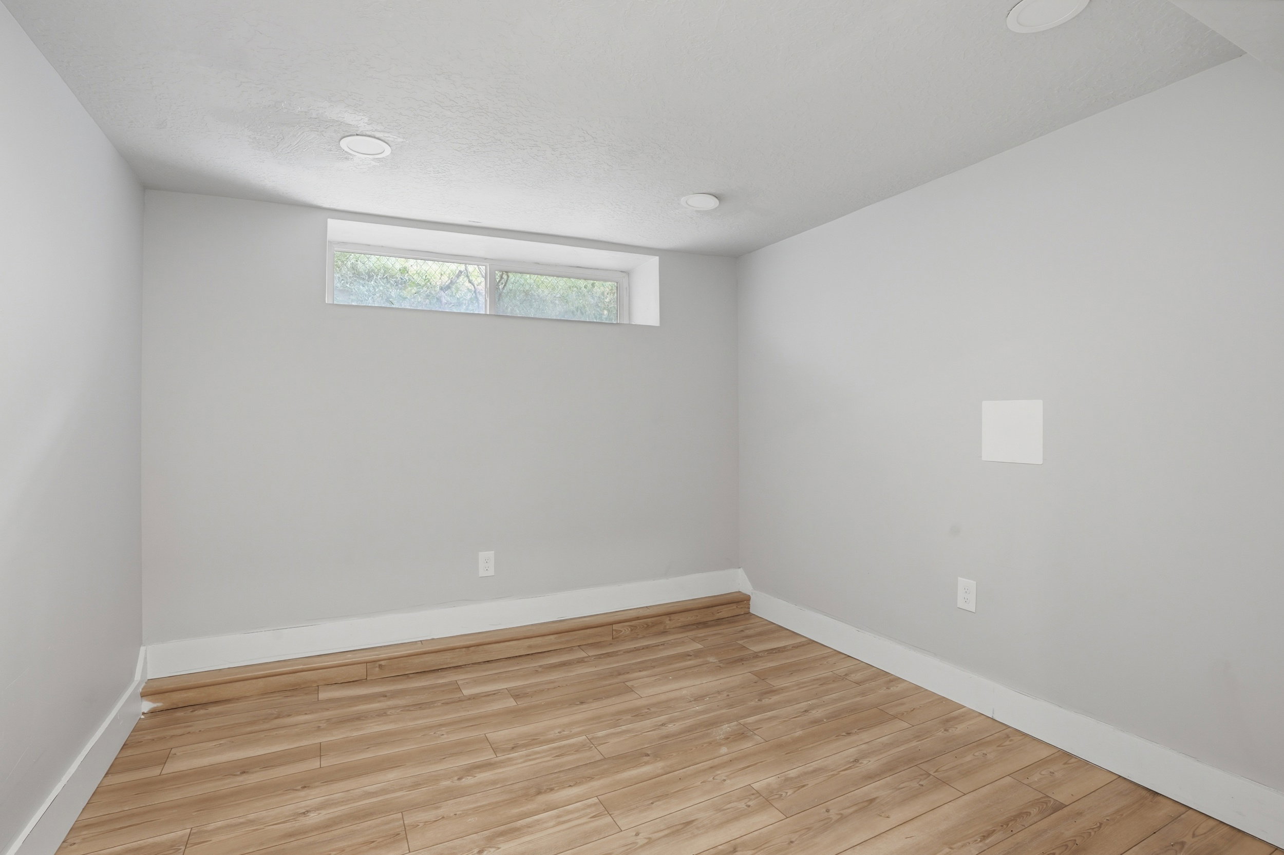 Unit #40 studio apartment with separate entrance. Spare room featuring light wood-style floors and baseboards