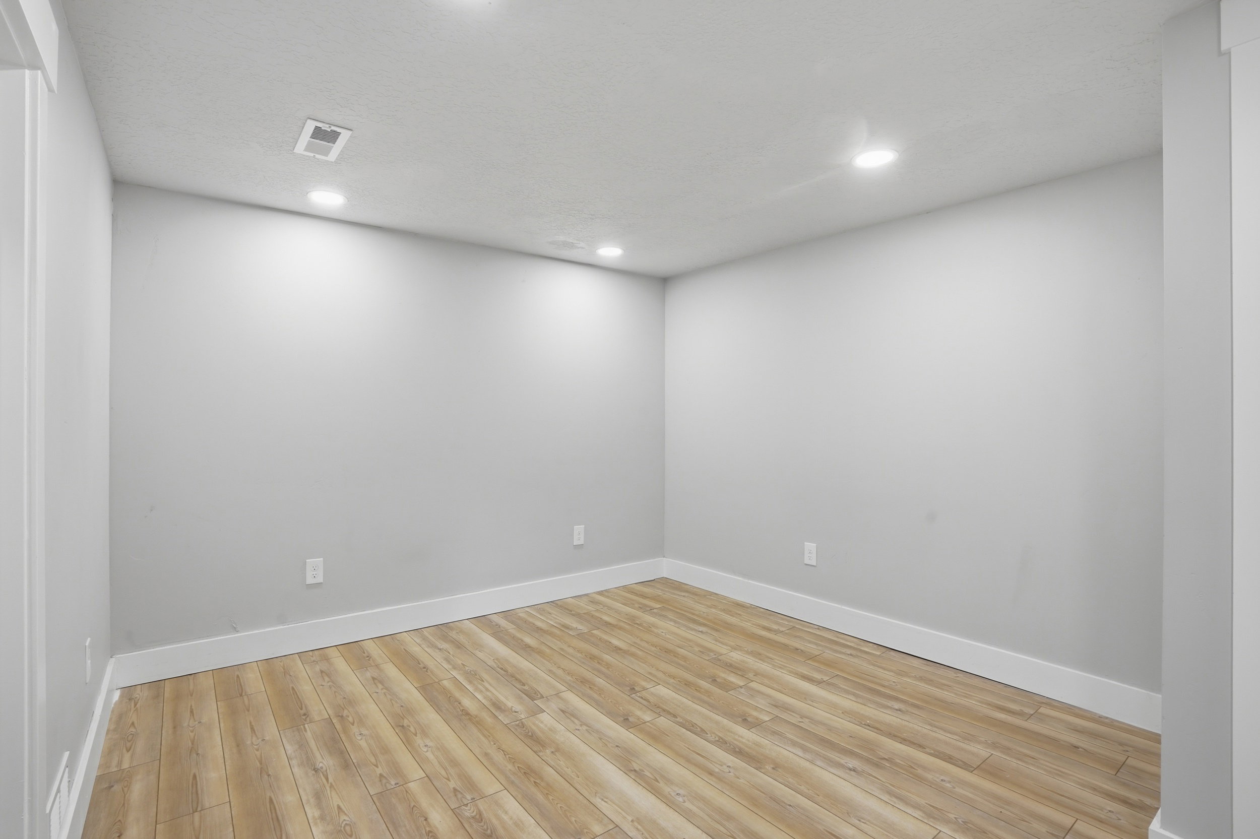 Unit #40 studio apartment with separate entrance.Empty room featuring light wood-type flooring and recessed lighting