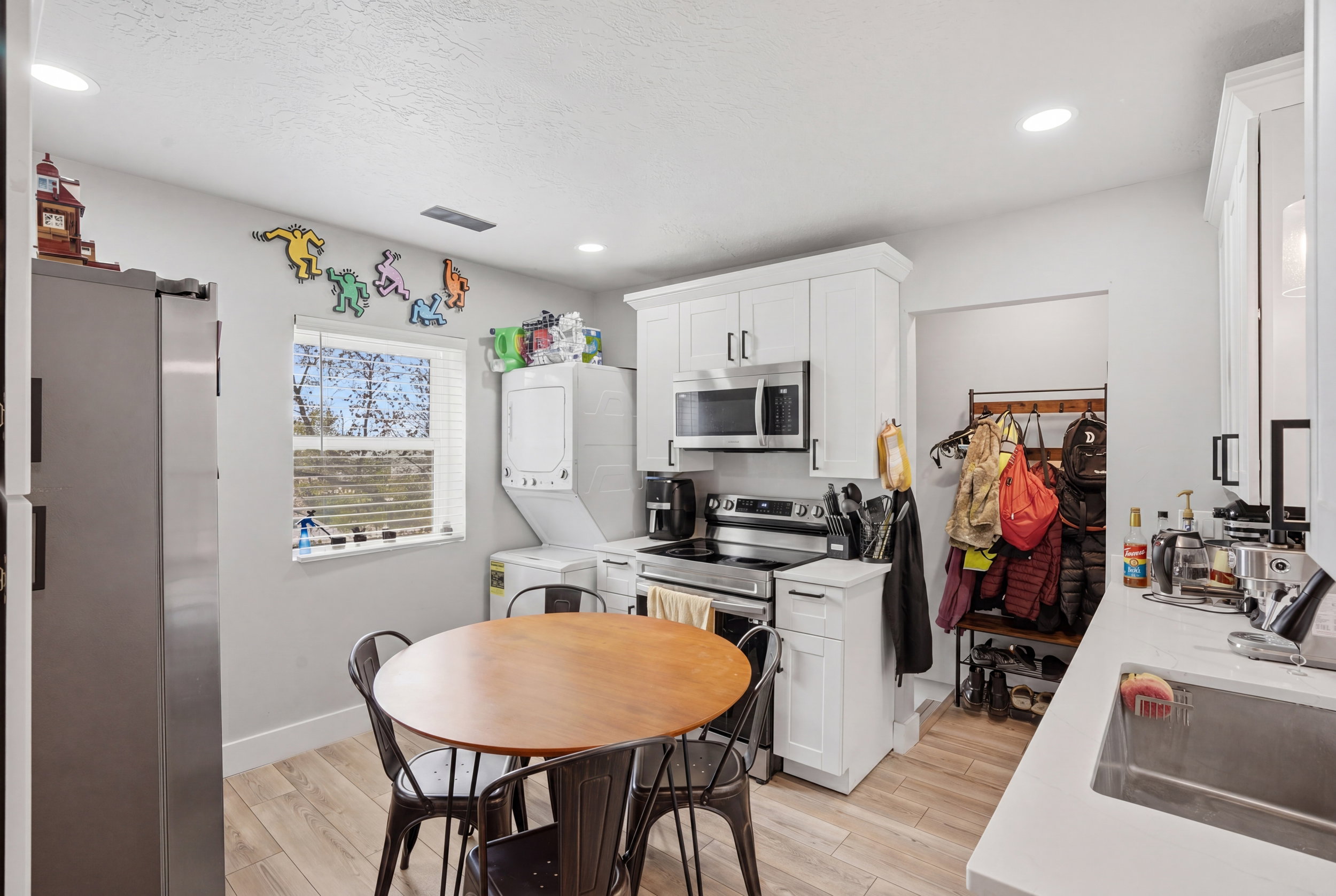 Unit #42 Kitchen featuring stainless steel appliances, light wood-type flooring, white cabinetry, and recessed lighting