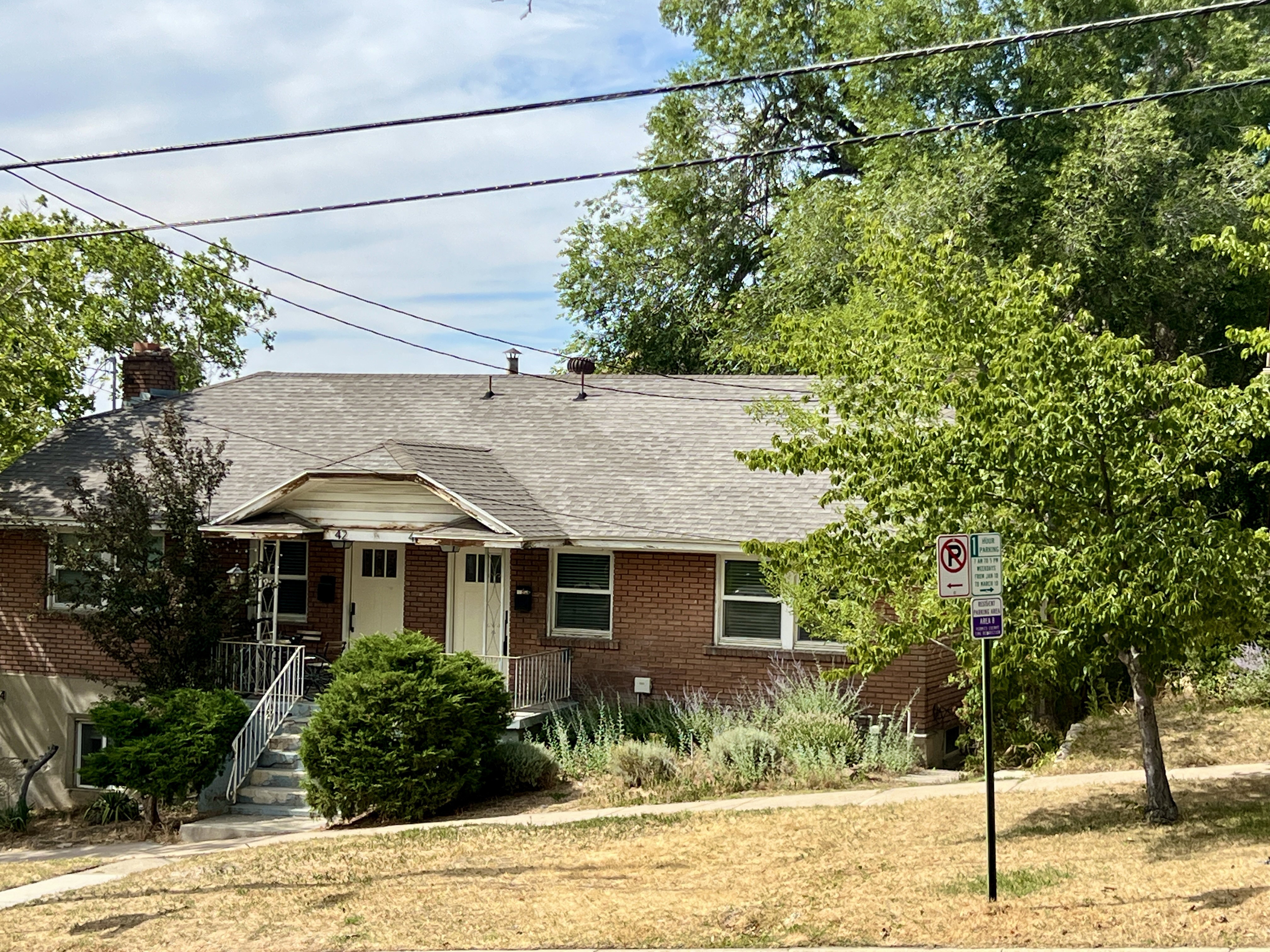 Brick exterior with a gabled roofline and chimney