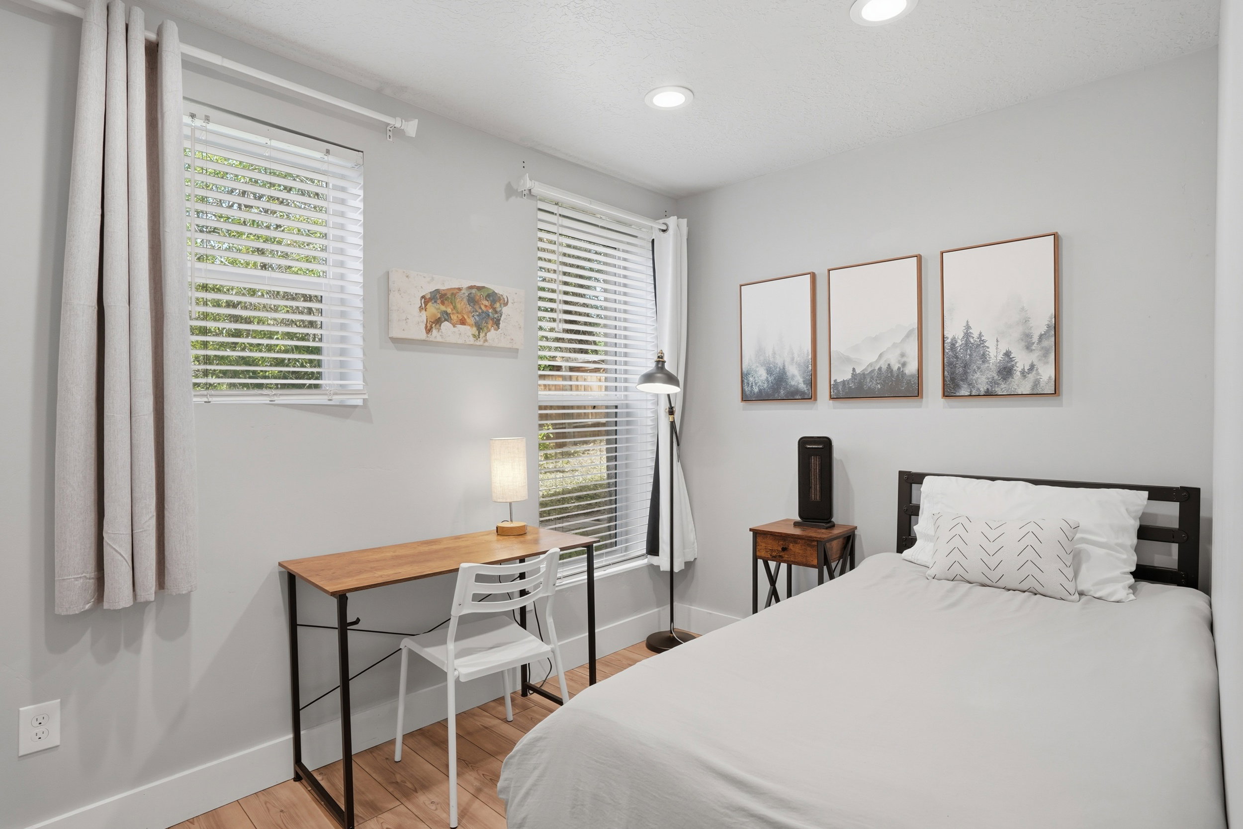 Furnished Unit #44 faces West. Bedroom featuring light wood-style flooring and recessed lighting
