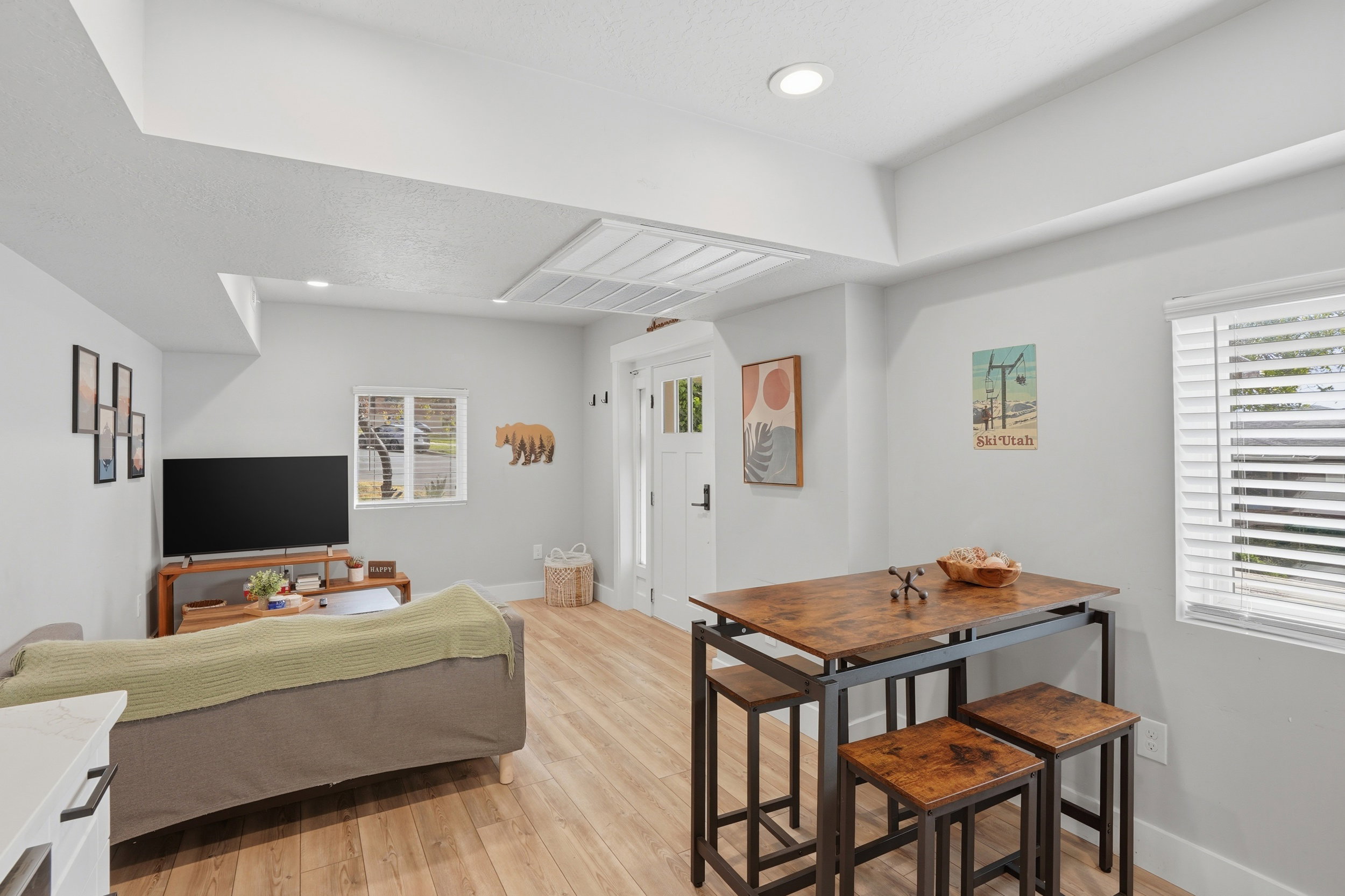 Furnished Unit #44 faces West. Living area featuring light wood-style flooring and recessed lighting