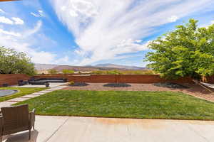 Fenced backyard with a mountain view and a patio area