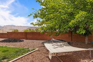 Fenced backyard with a mountain view