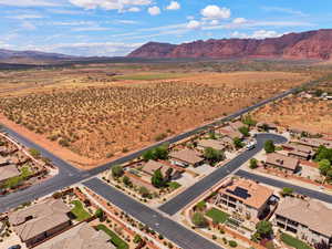 Aerial perspective of suburban area with a mountainous background and a desert landscape