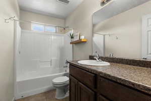 Full bathroom with vanity, tub / shower combination, and light tile patterned floors