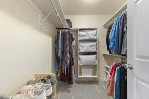Walk in closet featuring light carpet