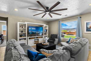 Living room with recessed lighting, ceiling fan, and tile patterned flooring