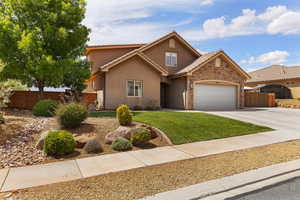 View of front of home featuring stucco siding, a garage, concrete driveway, a tiled roof, and stone siding