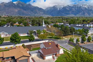 Aerial view of residential area with a mountainous background. .**Pictures of yard are AI generated and reflect grass in yard. Seller is having a new sprinkler system installed and will reseed the yard at buyer's request**