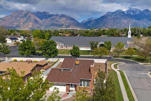 Aerial view of residential area with mountains. .**Pictures of yard are AI generated and reflect grass in yard. Seller is having a new sprinkler system installed and will reseed the yard at buyer's request**