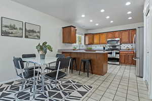 Kitchen featuring stainless steel appliances, wood finish cabinets,