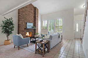 Living room with lofted ceiling, a brick fireplace,