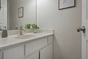 Bathroom with vanity and a textured wall