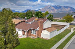 Aerial view of mountains. .**Pictures of yard are AI generated and reflect grass in yard. Seller is having a new sprinkler system installed and will reseed the yard at buyer's request**