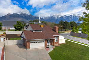 Views of front of house, mountain views. .**Pictures of yard are AI generated and reflect grass in yard. Seller is having a new sprinkler system installed and will reseed the yard at buyer's request**