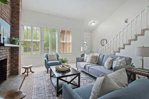 Living room with a brick fireplace and carpet