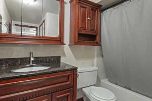 Basement Bath featuring vanity and shower / tub combo