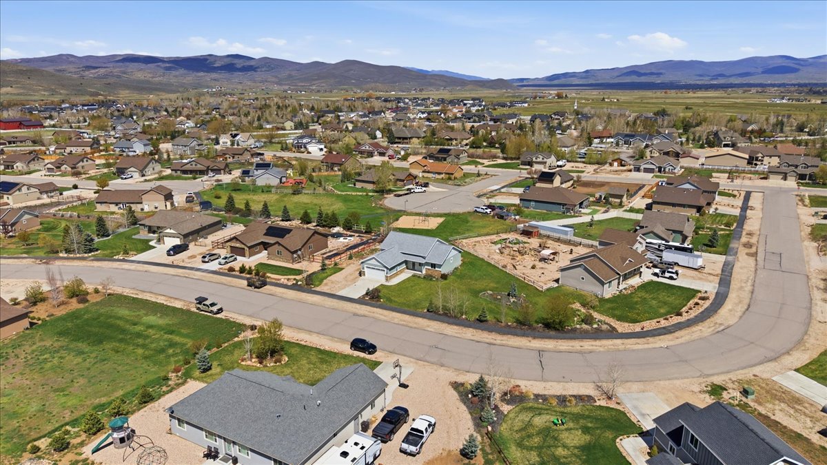 Aerial perspective of suburban area featuring a mountainous background