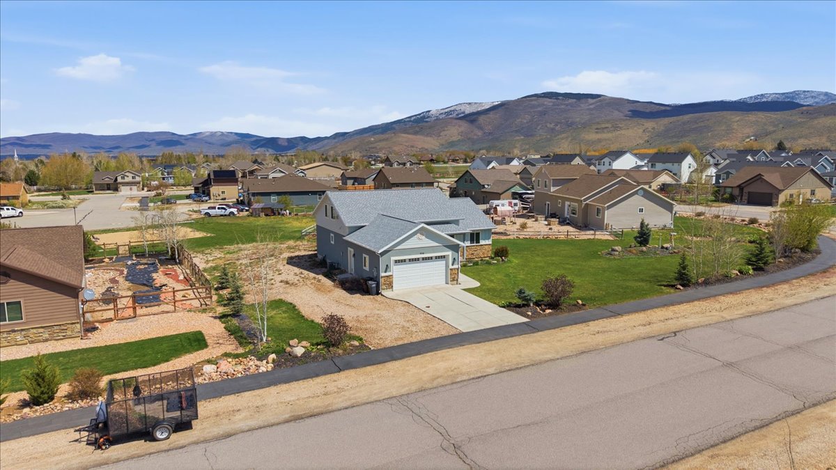 Aerial view of residential area featuring a mountainous background