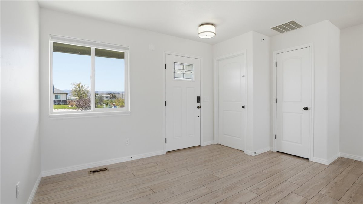 Foyer featuring light wood-type flooring and baseboards