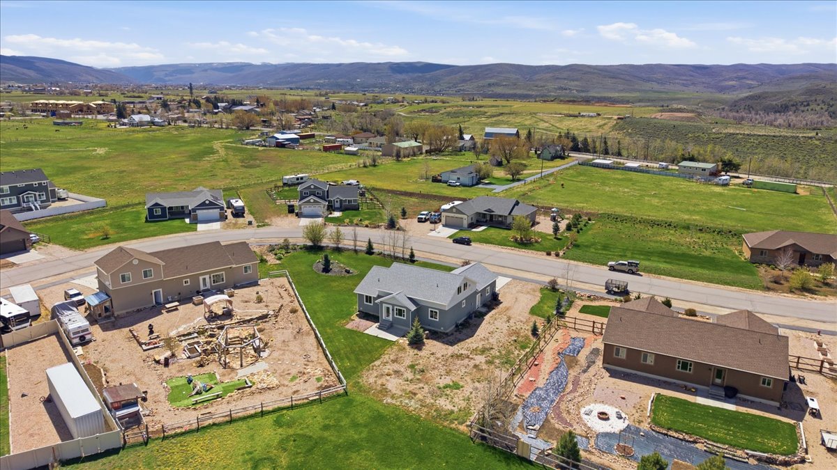Aerial view of property's location with mountains and nearby suburban area