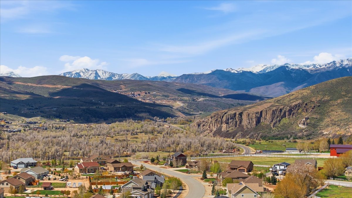 View of mountain backdrop featuring nearby suburban area