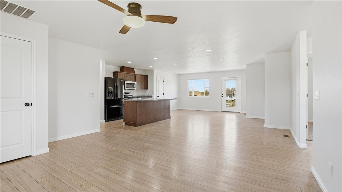 Unfurnished living room with a ceiling fan, light wood-type flooring, and recessed lighting