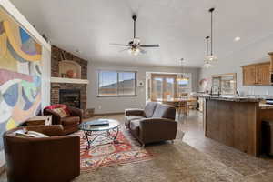Living room featuring a fireplace and ceiling fan